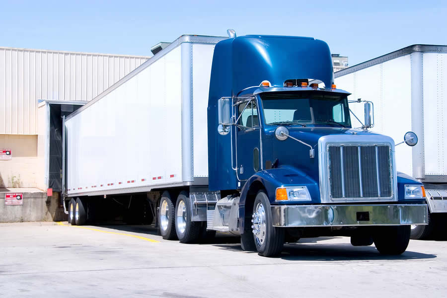 Truck delivering swing door storage trailer